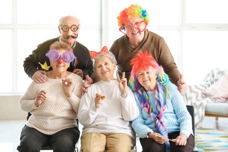 PACS-300x200-activity2 older seniors wearing fun wigs and masks for a party